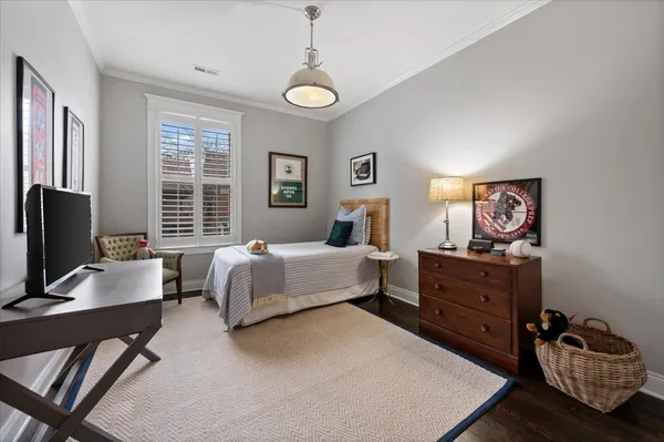 a living room with furniture a rug and a bookshelf