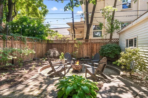 a view of a chairs and table in patio
