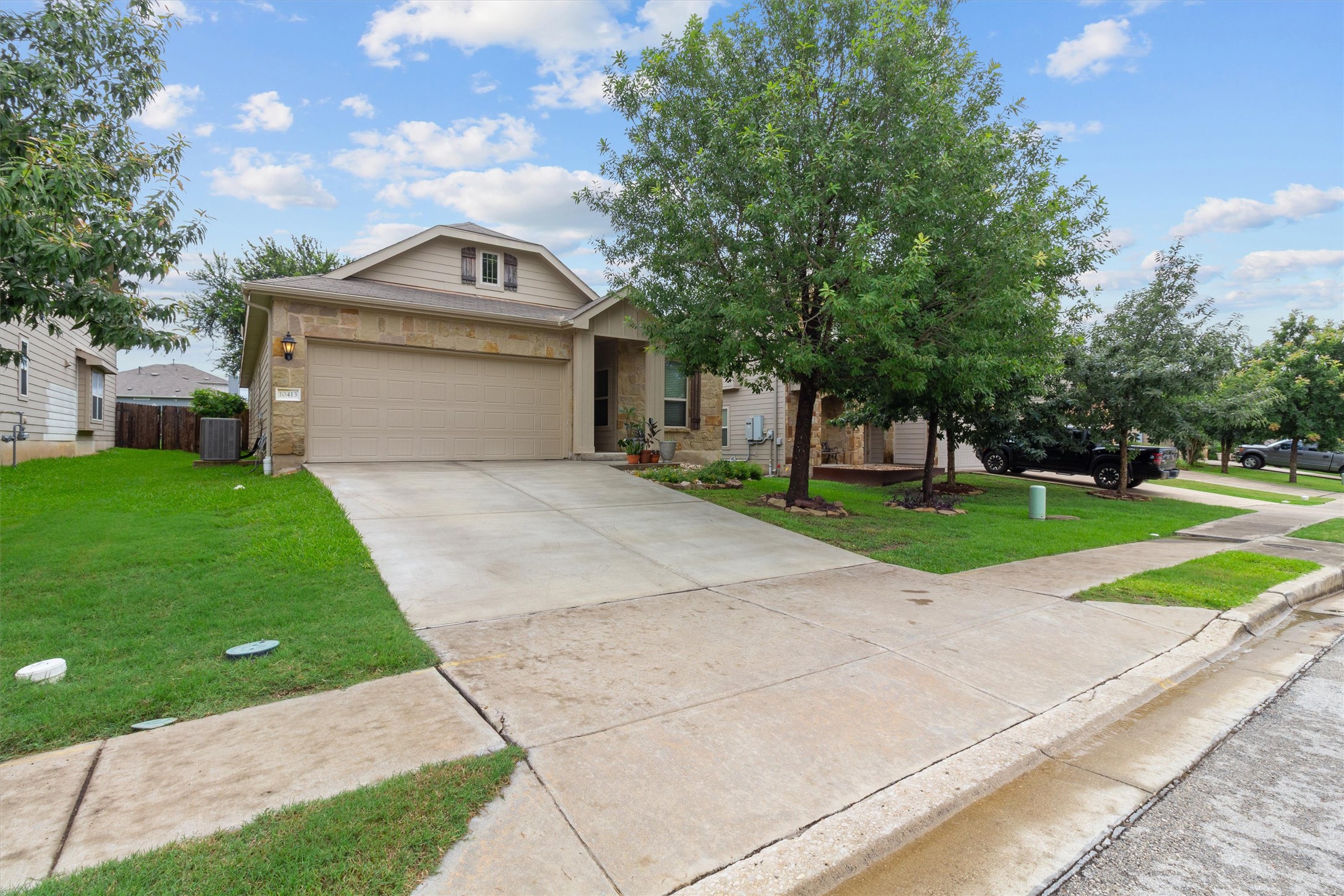 A welcoming single-story residence boasts an attached garage and mature trees, enhancing its curb appeal.