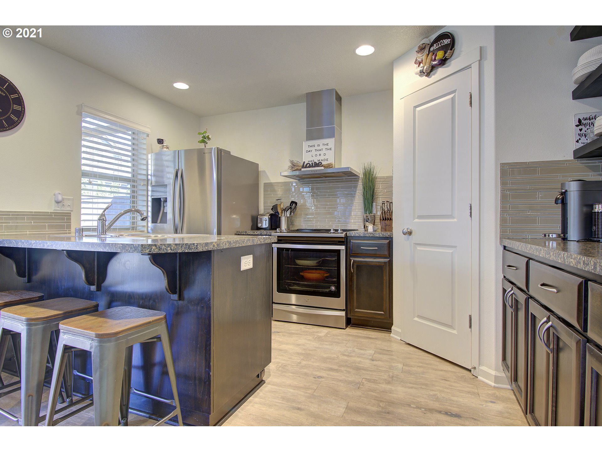 2312 South Sauk Way Ridgefield, WA 98642 - Photo 12 of 29 a kitchen with kitchen island granite countertop a sink cabinets and stainless steel appliances