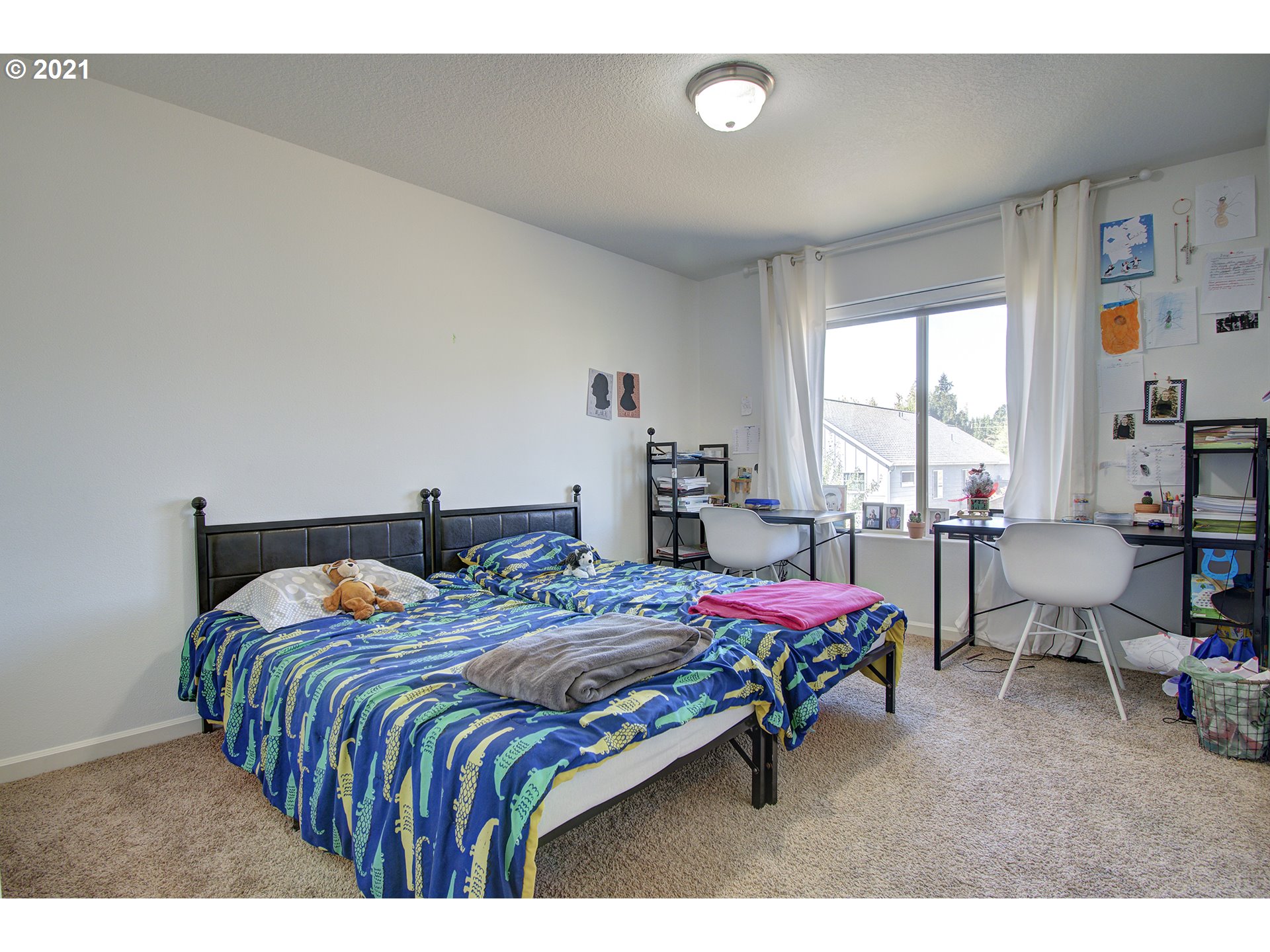 2312 South Sauk Way Ridgefield, WA 98642 - Photo 17 of 29 a bedroom with a bed and large windows