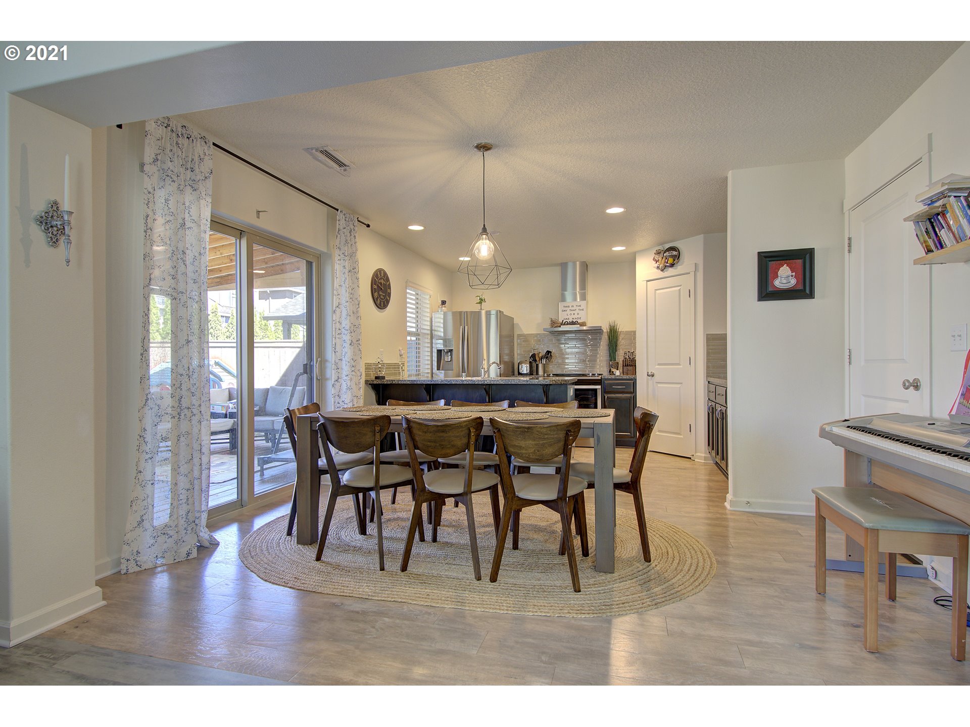 2312 South Sauk Way Ridgefield, WA 98642 - Photo 9 of 29 a dining room with furniture a chandelier and wooden floor