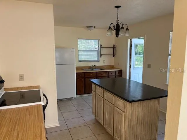 a kitchen with a sink a counter top space and cabinets