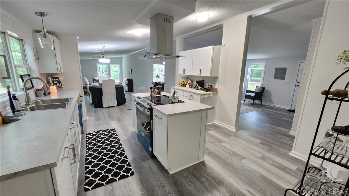 8065 Filly Run Road Gloucester, VA 23061 - Photo 8 of 33 Kitchen featuring island exhaust hood, light hardwood / wood-style floors, electric range, and pendant lighting