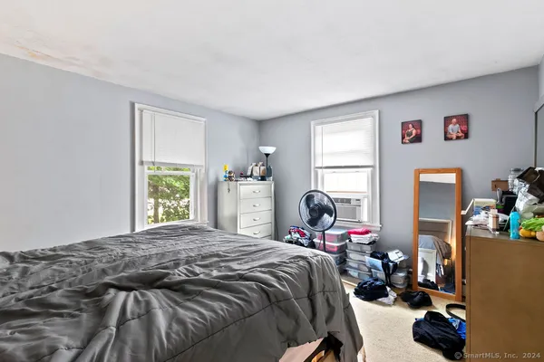 a bedroom with a bed and a dresser