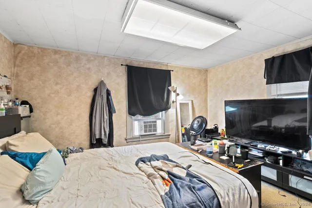 a living room with furniture and a floor to ceiling window