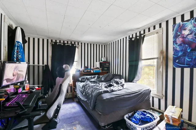 a bathroom with a granite countertop bathtub sink vanity mirror and toilet