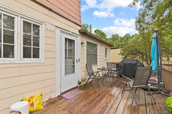 a view of a house with a yard and a tree