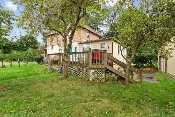 a view of a house with a yard and sitting area