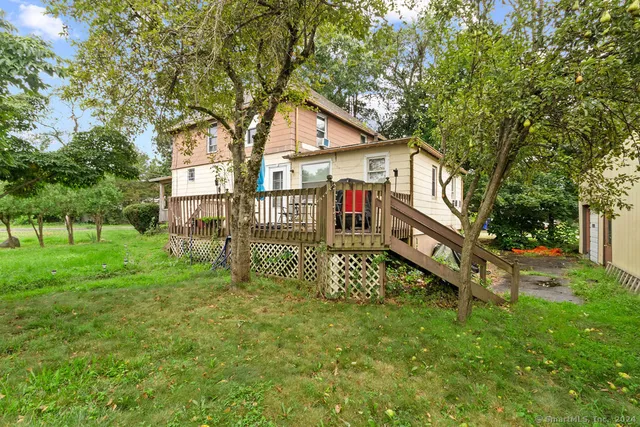 a view of a house with a yard and sitting area