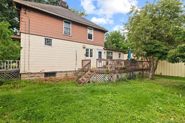a view of a house with a yard and sitting area
