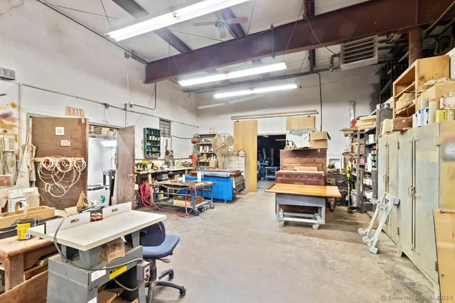 a view of a dining room with furniture and a kitchen view