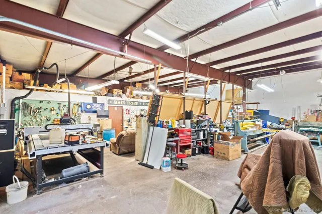 a view of a bedroom with baby crib and furniture