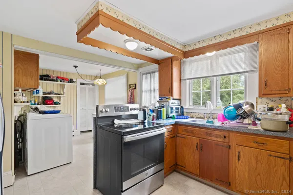 a kitchen with stainless steel appliances a refrigerator sink and cabinets