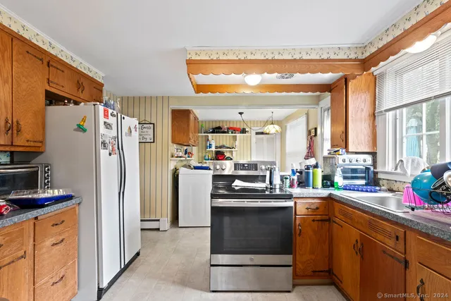a kitchen with stainless steel appliances a stove a sink and a microwave