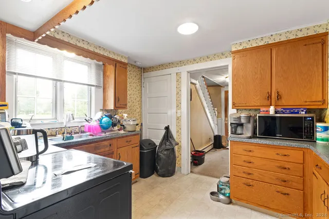 a kitchen that has a lot of cabinets in it