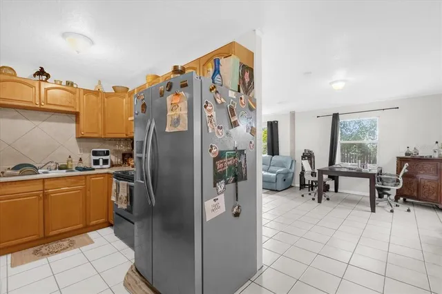 a kitchen with stainless steel appliances granite countertop a refrigerator and a sink