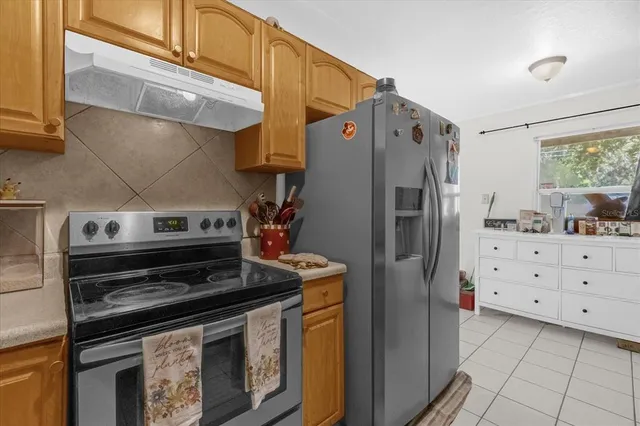 a kitchen with stainless steel appliances and cabinets