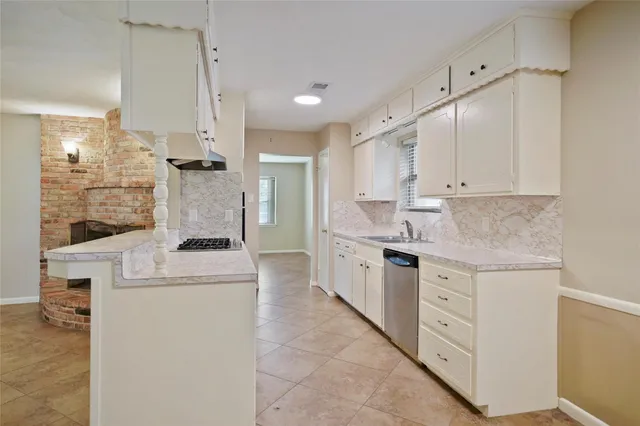 a kitchen with granite countertop a sink and cabinets