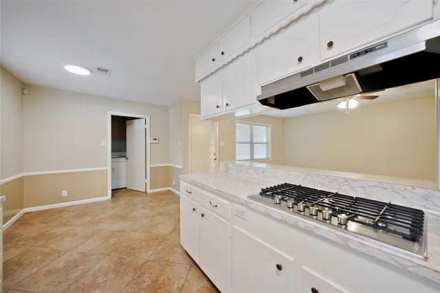 a kitchen with stainless steel appliances granite countertop a sink and cabinets