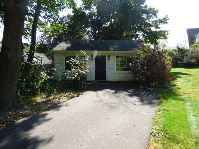a view of a house with a tree