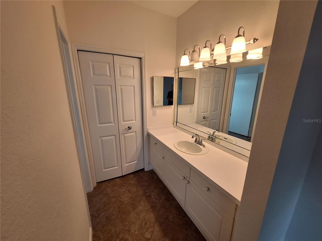 5140 Northridge Road, Unit 102 Sarasota, FL 34238 - Photo 11 of 32 a bathroom with a double vanity sink and mirror