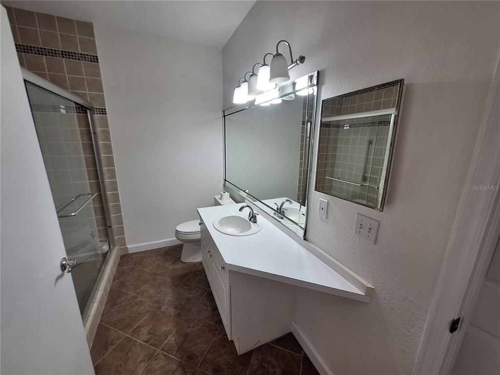 5140 Northridge Road, Unit 102 Sarasota, FL 34238 - Photo 16 of 32 a bathroom with a sink toilet and mirror