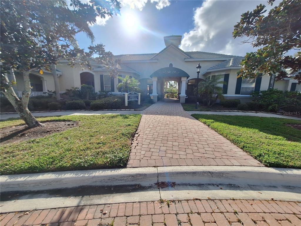 5140 Northridge Road, Unit 102 Sarasota, FL 34238 - Photo 24 of 32 a front view of a house with garden