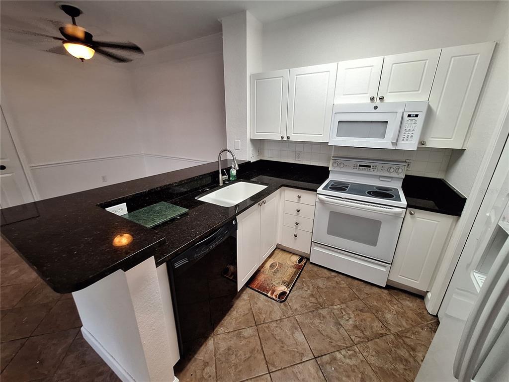 5140 Northridge Road, Unit 102 Sarasota, FL 34238 - Photo 5 of 32 a kitchen with a sink appliances and cabinets