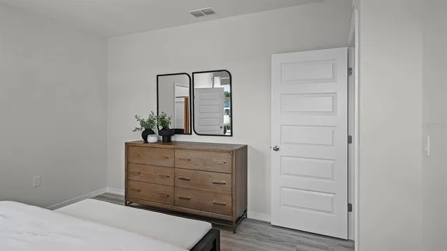 a bedroom with a bed and a dresser