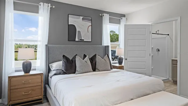 a bedroom with a bed and wooden floor