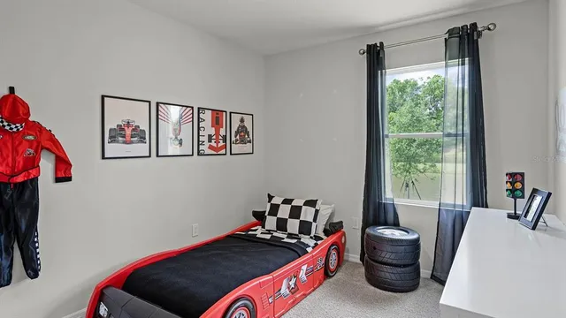 a bedroom with furniture and a window