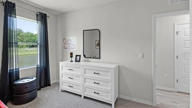 a bedroom with a bed and a potted plant