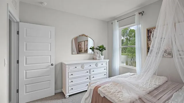 a bedroom with a bed and a lamp