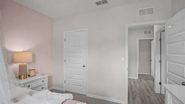 a bedroom with a bed and a dresser
