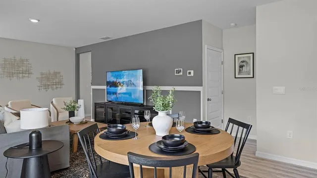 a view of a dining room with furniture and wooden floor