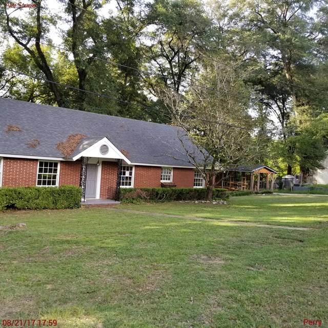 705 Charlse Drive Perry, GA 31069 - Photo 1 of 20 a front view of a house with a garden