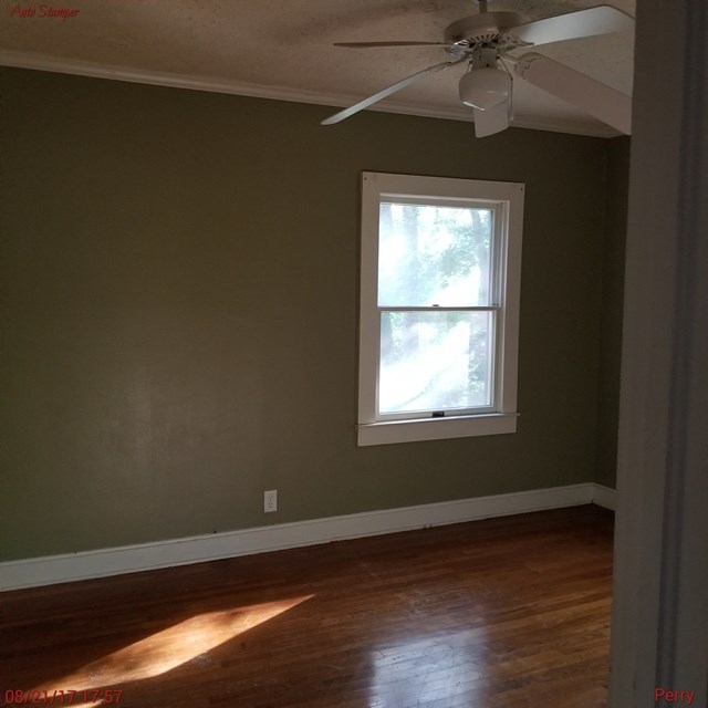 705 Charlse Drive Perry, GA 31069 - Photo 14 of 20 a view of an empty room with wooden floor and a window