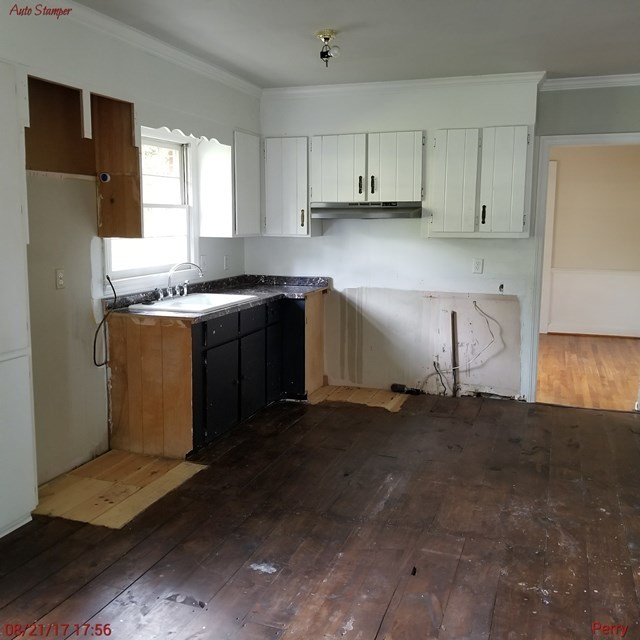 705 Charlse Drive Perry, GA 31069 - Photo 6 of 20 a kitchen with stainless steel appliances granite countertop a stove a sink and a refrigerator
