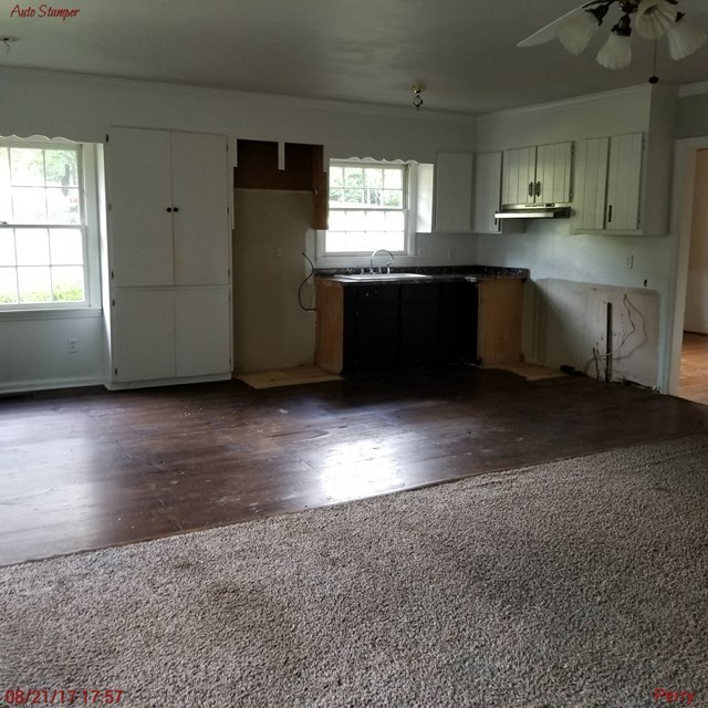 705 Charlse Drive Perry, GA 31069 - Photo 10 of 20 a kitchen with granite countertop a sink cabinets and window