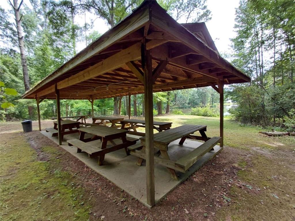 17 Valley Trail Covington, GA 30014 - Photo 18 of 19 a view of a backyard with table and chairs under an umbrella with a small yard