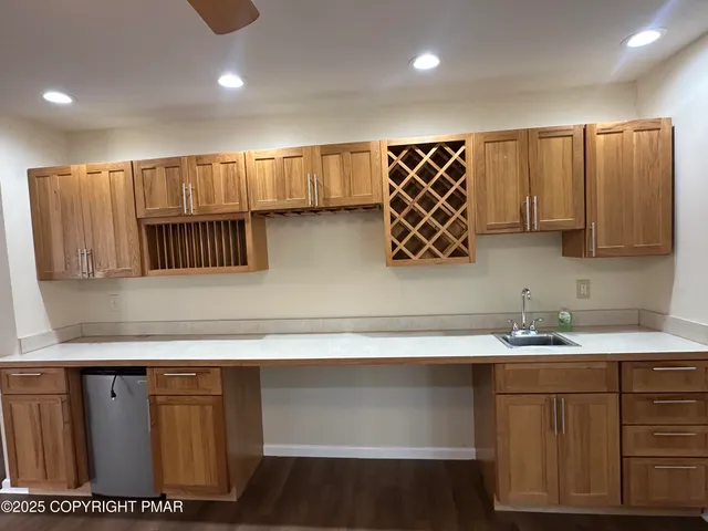 a kitchen with a sink cabinets and a window