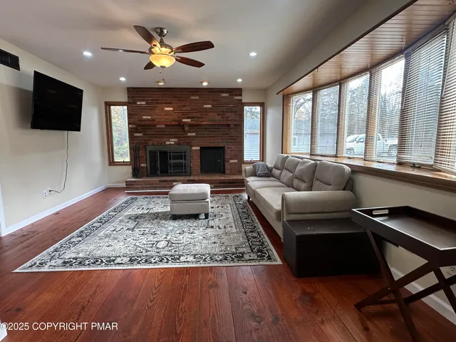 a living room with furniture and wooden floor