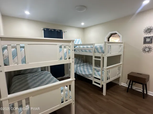 a spacious bedroom with a bed and a window