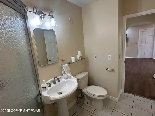 a bathroom with a toilet and a mirror