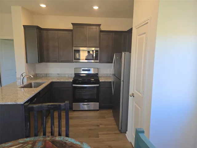 a kitchen with a refrigerator and a sink