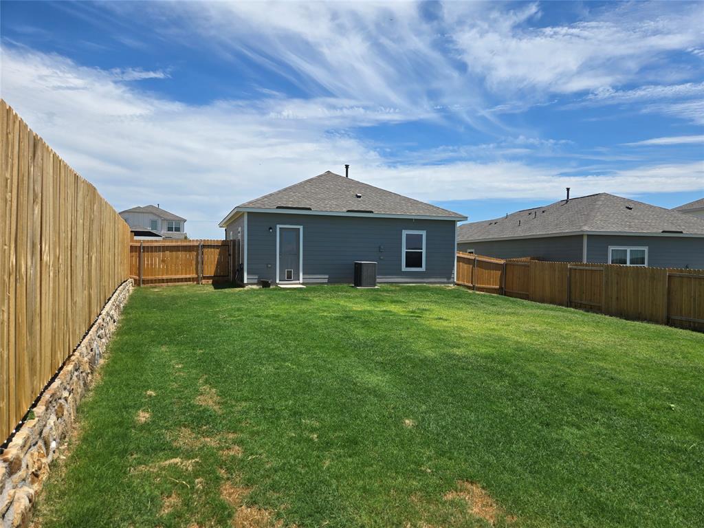8425 Wibaux Road Ponder, TX 76259 - Photo 6 of 25 a front view of a house with a garden