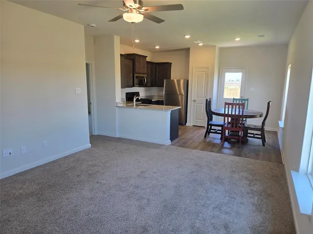 a view of a kitchen with furniture and a window