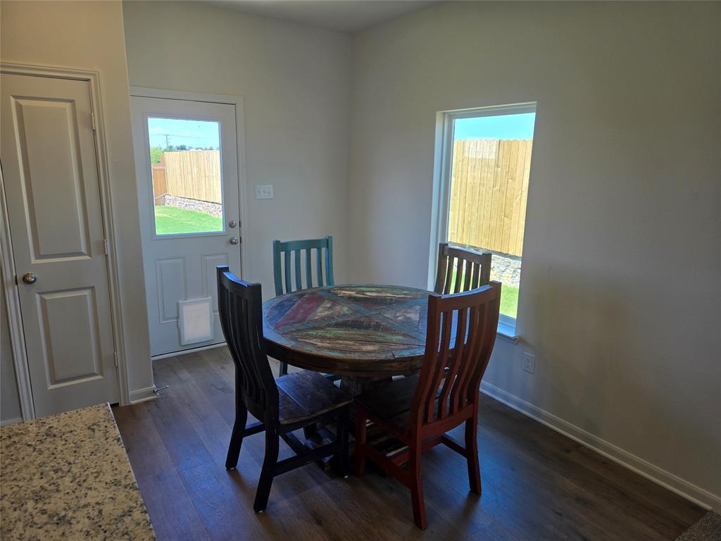 8425 Wibaux Road Ponder, TX 76259 - Photo 10 of 25 a view of a dining room with furniture and wooden floor