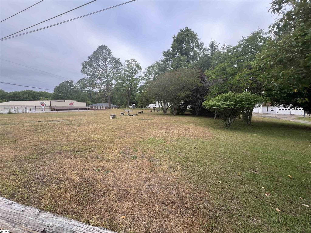 202 North Hamilton Street Williamston, SC 29697 - Photo 1 of 1 Commercial/ Residential Corner Lot in Williamston. Expansive outdoor space offering verdant greenery, trees, and boundless potential.